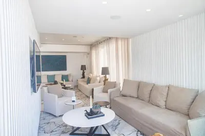 a living room with a couch and chairs and a table at Kokkinos Boutique Hotel in Protaras