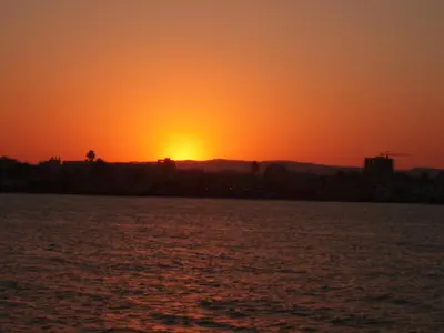 an orange sunset over a body of water at Mediterranean Sunrise Complex in Voroklini
