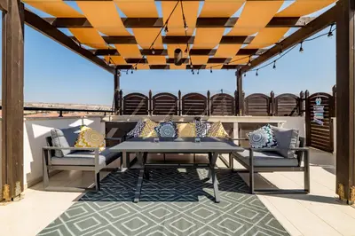a patio with a table and chairs on a roof at Blue Serenity Complex in Larnaka