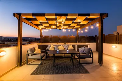 a patio with a table and chairs on a roof at Blue Serenity Complex in Larnaka