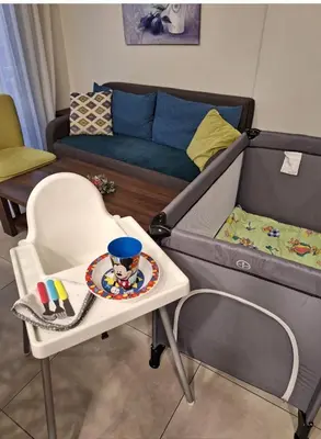 a living room with a bed and a chair at By The Way Apartment in Larnaka