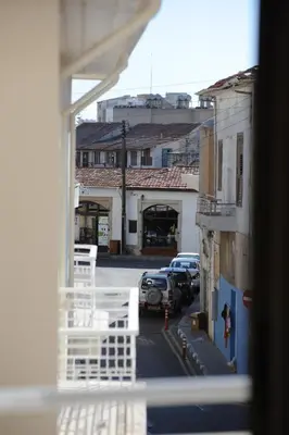 a view from a window of a street with parked cars at By The Way Apartment in Larnaka