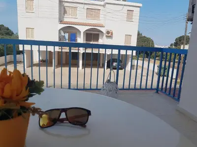 a pair of sunglasses sitting on a table on a balcony at Cozy holyday apartament in Paralimni