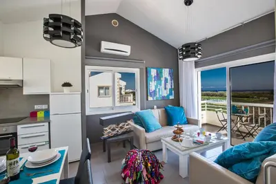 a living room with a couch and a table at Nicholas Seaview Apartments in Protaras