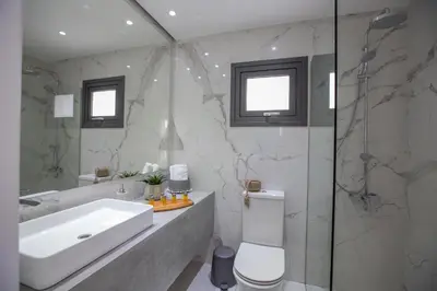 a bathroom with a sink and a toilet and a shower at Nicholas Seaview Apartments in Protaras