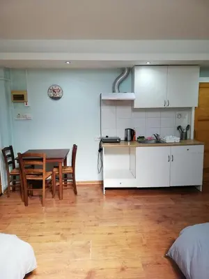 a kitchen and dining room with a table and chairs at Swallows Nest in Larnaka