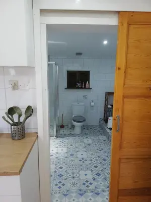 a bathroom with a toilet and a tile floor at Swallows Nest in Larnaka