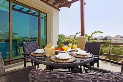 a table with food and fruit on a balcony at Villa Marion in Ayia Napa