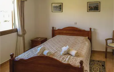 a bedroom with a bed with two pillows on it at Stunning Home In Maroni-Larnaca in Pervolia