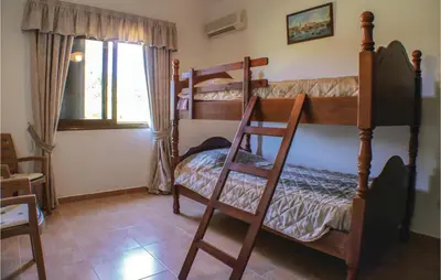 a bedroom with two bunk beds and a window at Stunning Home In Maroni-Larnaca in Pervolia