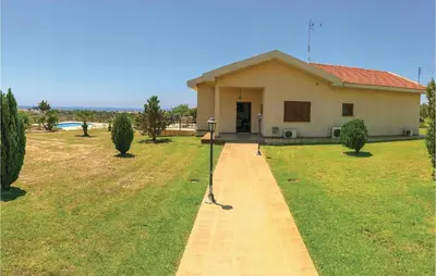 a house with a walkway in front of it at Stunning Home In Maroni-Larnaca in Pervolia