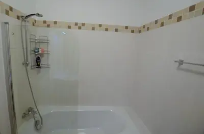 a bathroom with a shower with a glass door at Violet Dusk City Center Flat in Larnaka