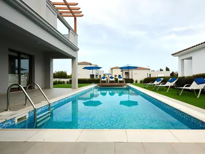 a swimming pool in the backyard of a house at Angie Luxury Beach Villas in Ayia Napa