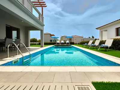 a swimming pool in the backyard of a house at Angie Luxury Beach Villas in Ayia Napa