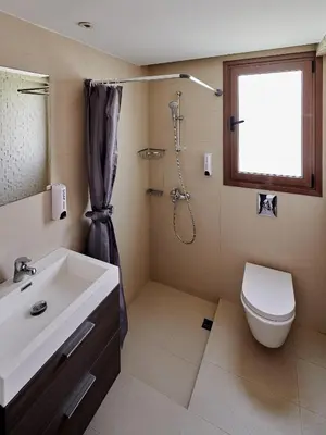 a bathroom with a sink and a toilet and a shower at Angie Luxury Beach Villas in Ayia Napa