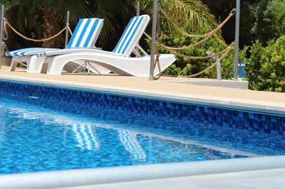 two chairs sitting next to a swimming pool at St.George's Country Retreat in Limassol