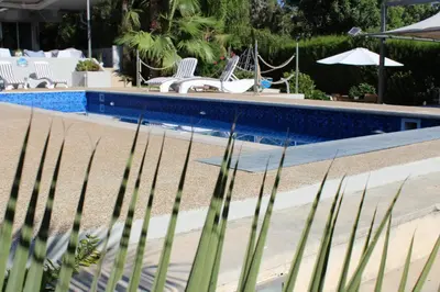 a swimming pool with chairs and a fence next to it at St.George's Country Retreat in Limassol