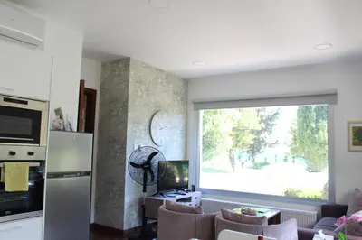 a living room with a large window and a couch at St.George's Country Retreat in Limassol