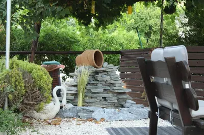 a garden with a hat and a stone wall at St.George's Country Retreat in Limassol