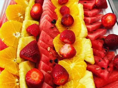 a plate of fruit with oranges oranges and strawberries at Adelais Bay Hotel in Protaras