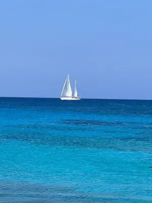 a sailboat in the ocean with blue water at Adelais Bay Hotel in Protaras