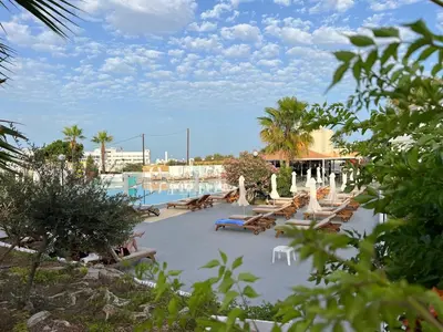 a resort with a pool with lounge chairs and a pool at Adelais Bay Hotel in Protaras