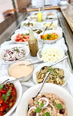 a buffet with many plates of food on a table at Adelais Bay Hotel in Protaras