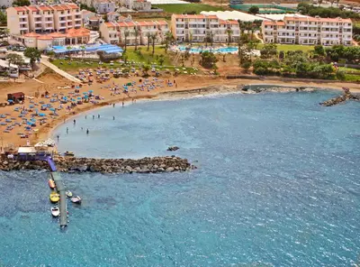 an aerial view of a beach with people and umbrellas at MyroAndrou Beach Hotel Apartments in Protaras