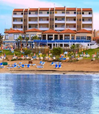 a hotel on the beach with chairs and umbrellas at MyroAndrou Beach Hotel Apartments in Protaras