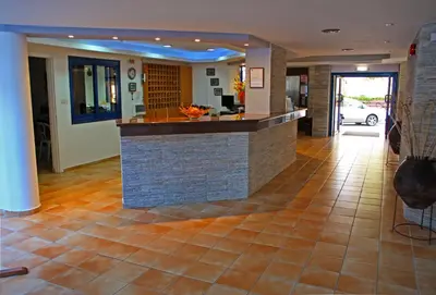 a lobby with a bar in the middle of a building at MyroAndrou Beach Hotel Apartments in Protaras
