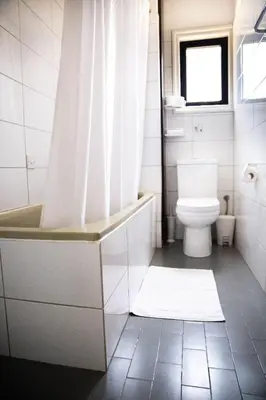 a bathroom with a tub and a toilet and a shower at Olive Island in Larnaka