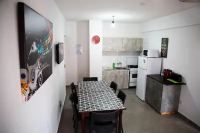a kitchen with a table and a kitchen with a refrigerator at Olive Island in Larnaka