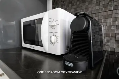 a white microwave sitting on a counter next to at Lazuli Seaview Apartments 2Bdr in Larnaka