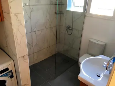 a bathroom with a shower and a toilet and a sink at Villa Emiliana in Paralimni