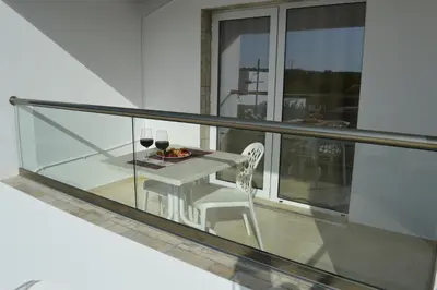 a balcony with a table and a plate of food at Millie's Apartments in Ayia Napa