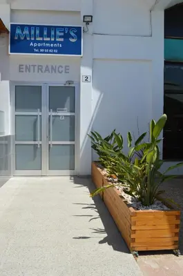 an entrance to a building with a glass door at Millie's Apartments in Ayia Napa