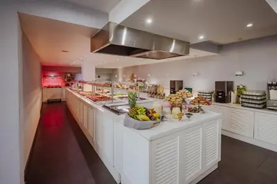 a large kitchen with a counter with fruit on it at Tasia Maris Oasis in Ayia Napa