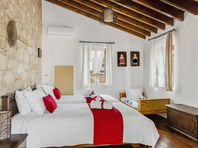 a bedroom with two beds with red and white pillows at Arsorama Village Homes in Arsos