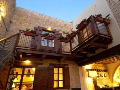 a building with a balcony with plants on it at Arsorama Village Homes in Arsos