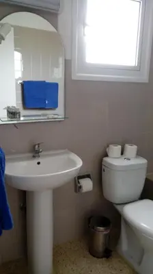 a bathroom with a sink and a toilet and a mirror at Flokkas Hotel Apartments in Protaras