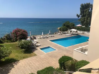 a view of a swimming pool and the ocean at Gulf Palace Apartments in Limassol