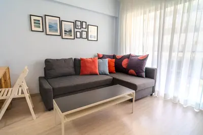 a living room with a couch and a coffee table at Helios Mackenzie One Bedroom Flat in Larnaka