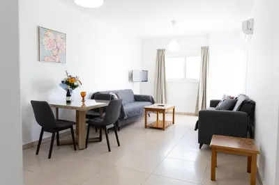 a living room with a couch and a table at Christothea Apartments in Ayia Napa