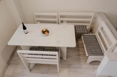 a white table with a bowl of fruit on it at Pirgos beach house in Larnaka