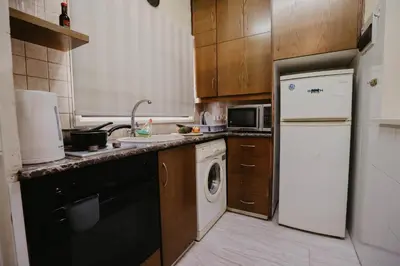 a kitchen with a white refrigerator and a dishwasher at Pirgos beach house in Larnaka