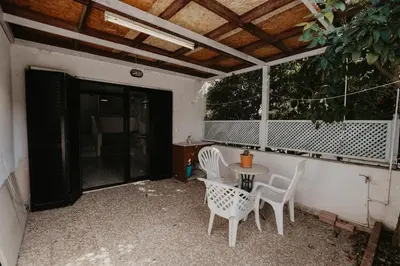 a patio with two chairs and a table and a window at Pirgos beach house in Larnaka