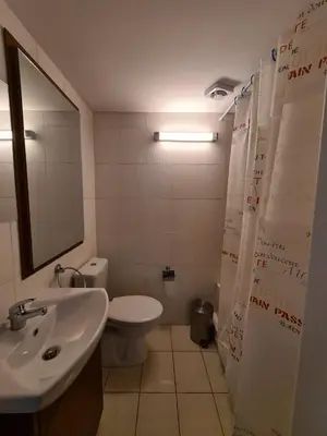 a bathroom with a sink and a toilet and a mirror at Christiana's stone studios in Pano Lefkara