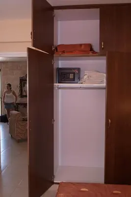 a refrigerator with a microwave sitting on top of it at Kotzias Beach Apartments in Pissouri