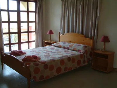 a bedroom with a bed with a large window at Pelekanos Apartments in Pissouri