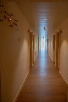 a hallway of an empty room with wooden floors at Tylos Beach Hotel in Kato Pyrgos